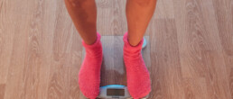A girl worried about the weighing scale