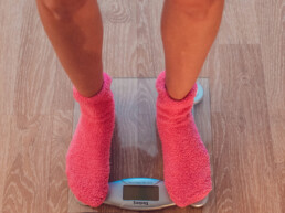 A girl worried about the weighing scale