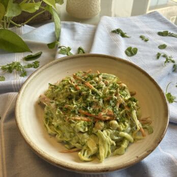 Healthy vegetable salad with herbs on ceramic plate, colourful, fresh ingredients, rustic charm, natural light.
