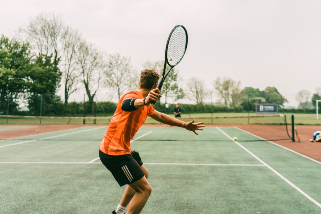 playing tennis outdoors